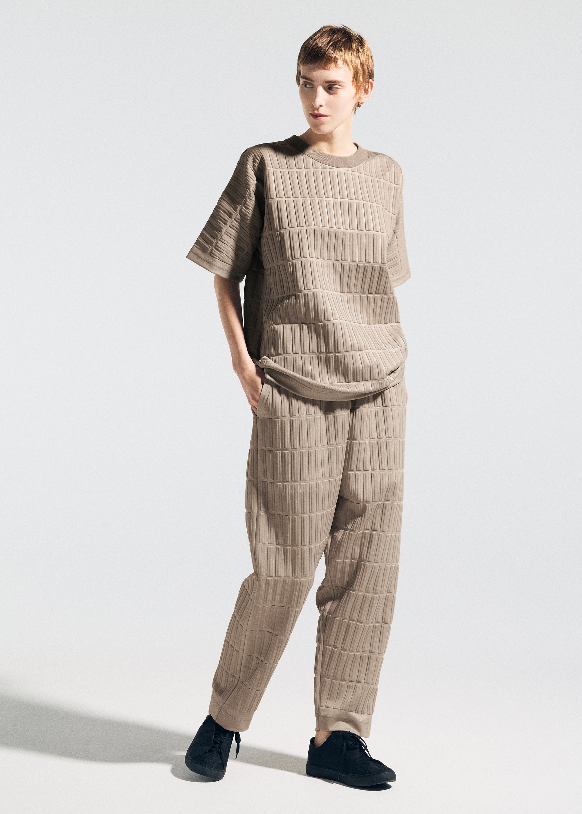 A model wears the A-POC ABLE ISSEY MIYAKE TYPE E 001 trousers.