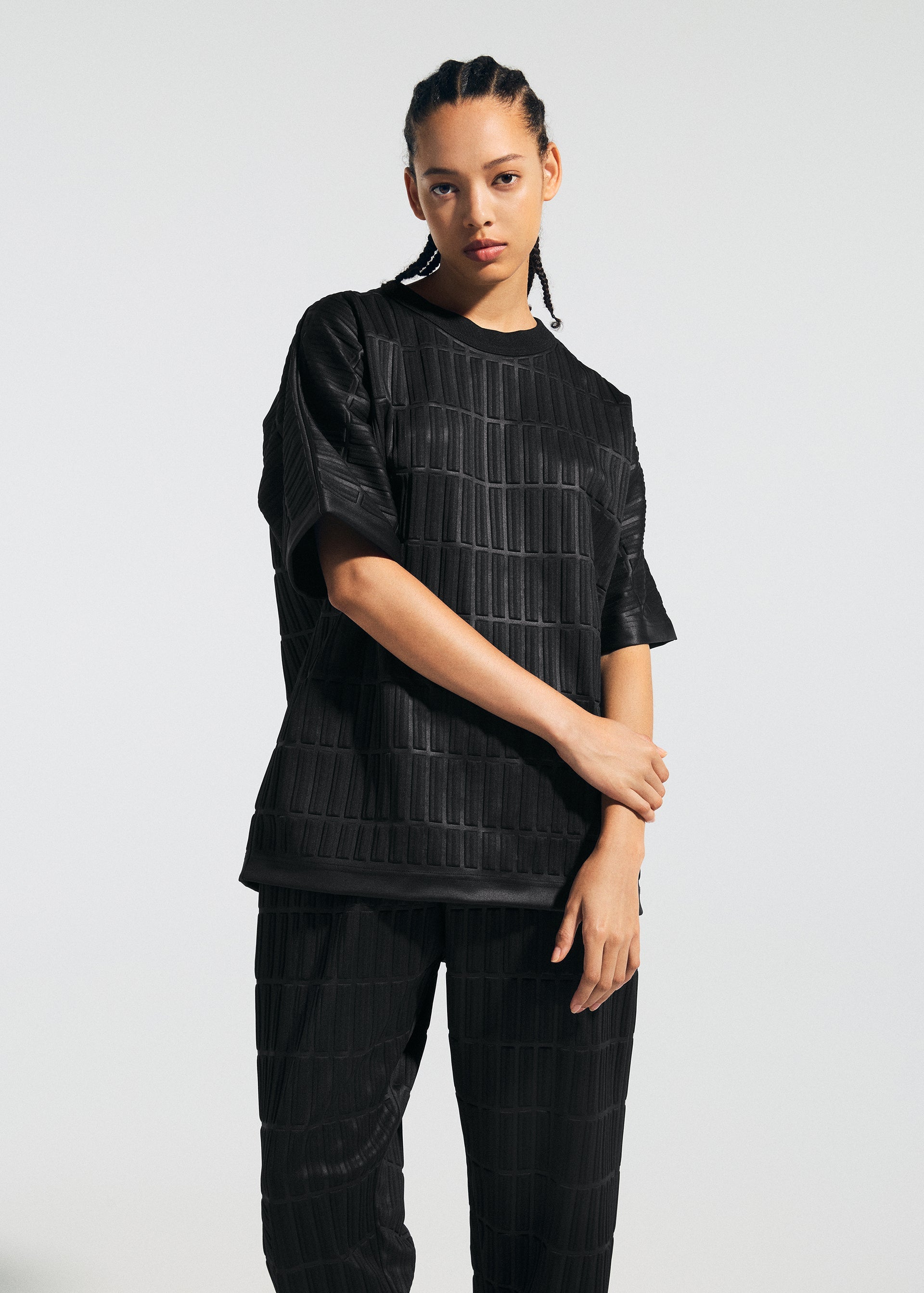 A model wears the A-POC ABLE ISSEY MIYAKE TYPE E 001 trousers.