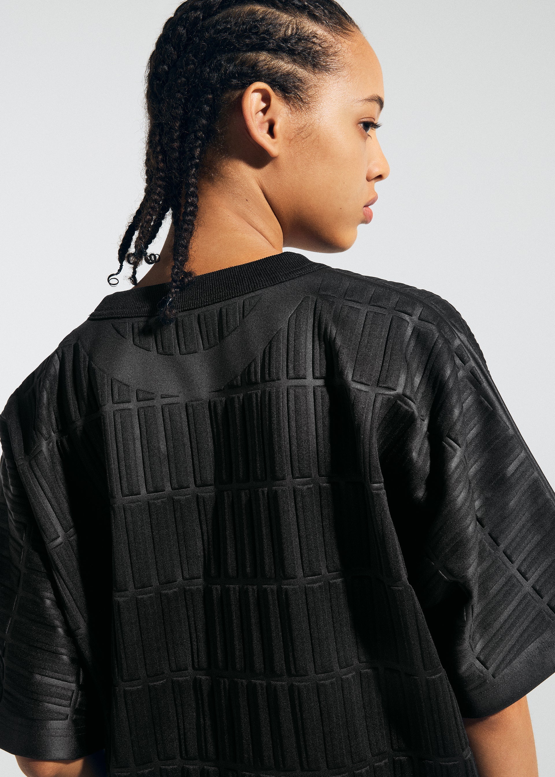 A model wears the A-POC ABLE ISSEY MIYAKE TYPE E 001 top.