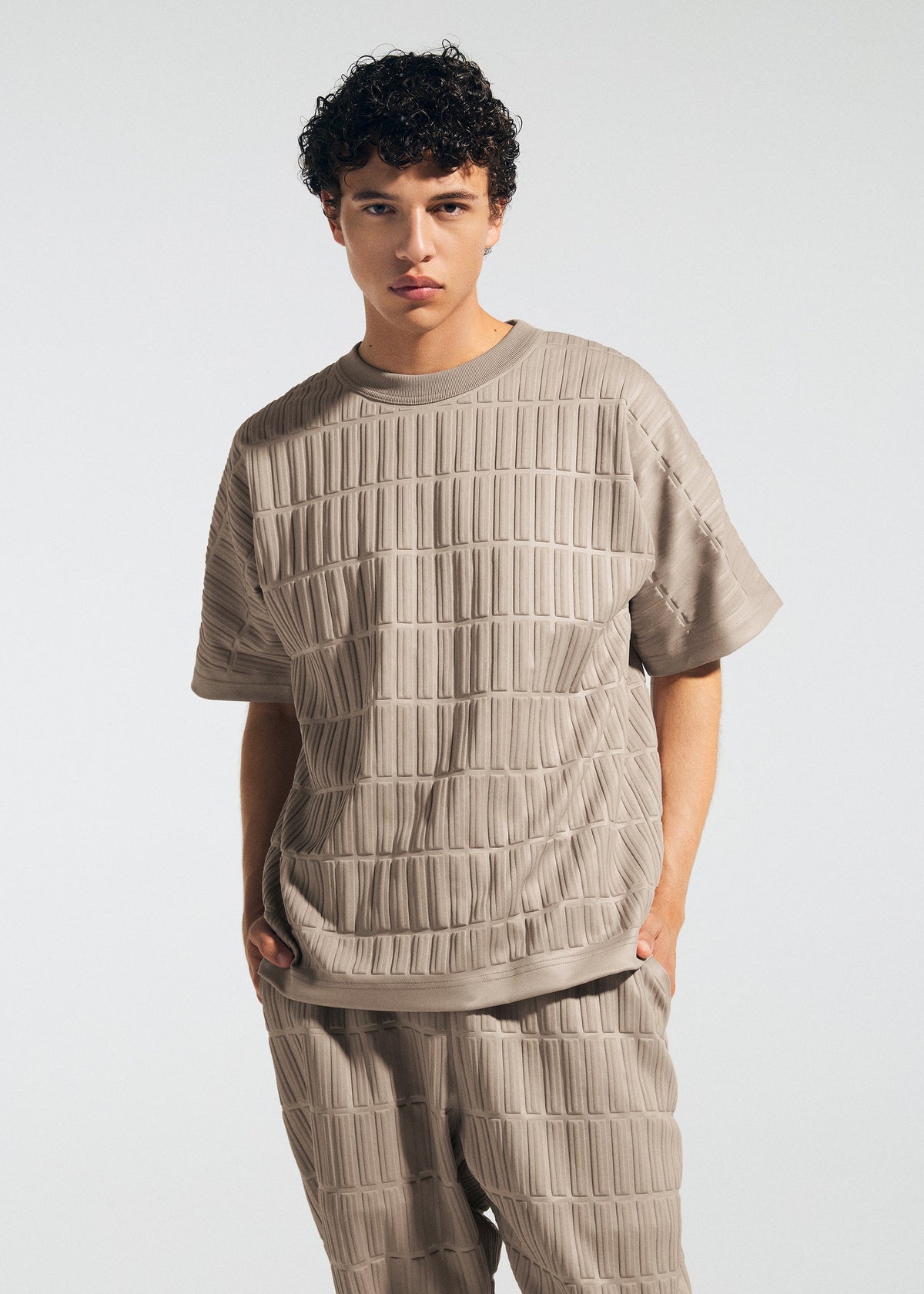 A model wears the A-POC ABLE ISSEY MIYAKE TYPE E 001 top.