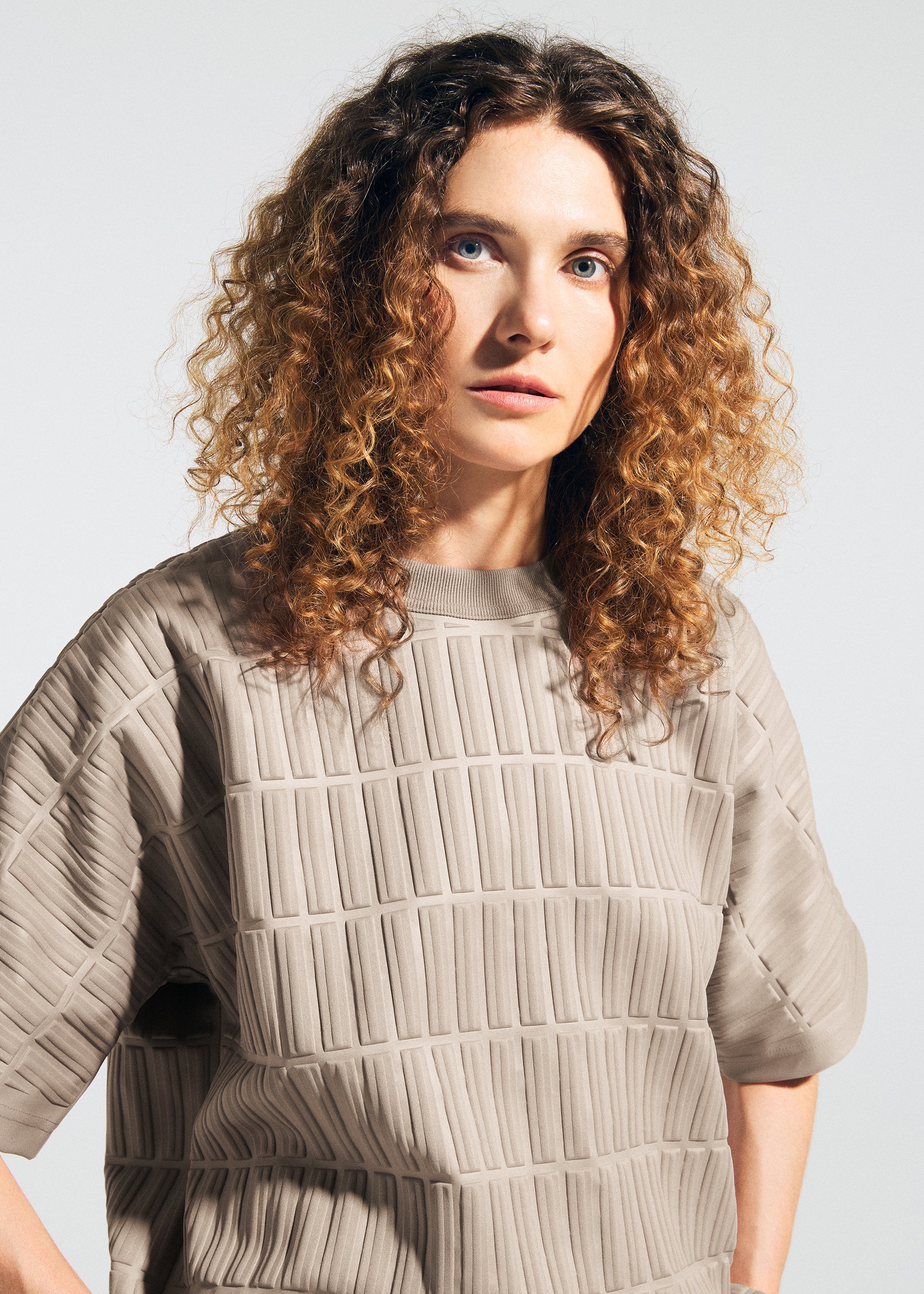 A model wears the A-POC ABLE ISSEY MIYAKE TYPE E 001 top.