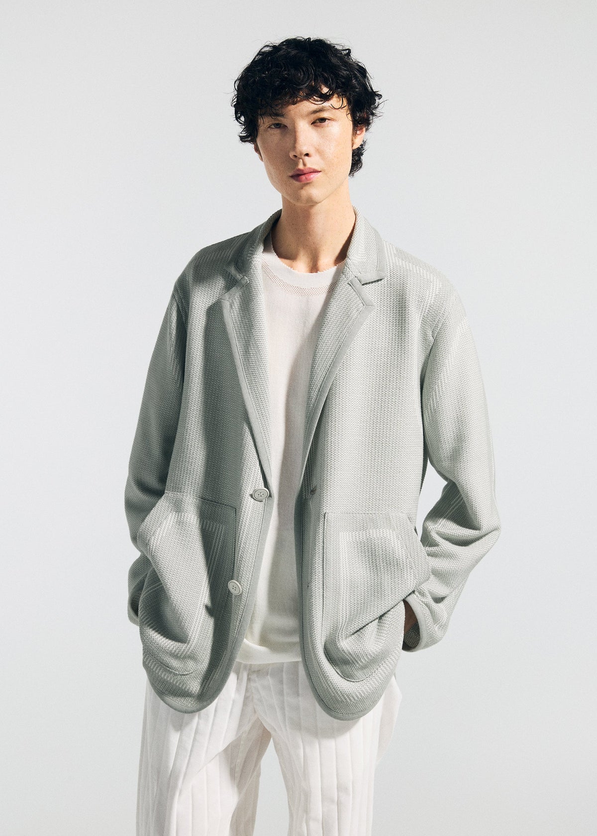 A model wears the A-POC ABLE ISSEY MIYAKE TYPE K 008 jacket.
