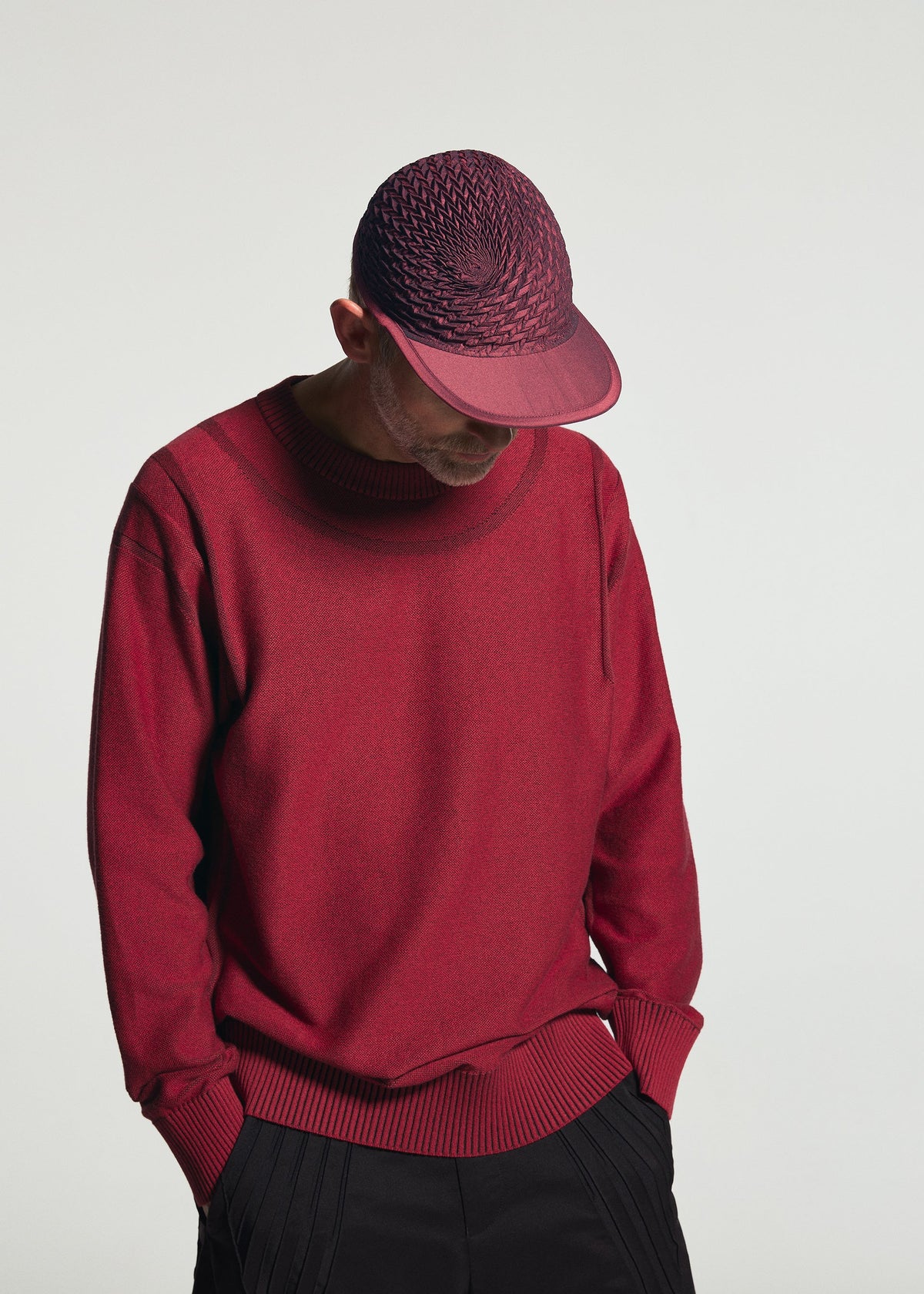 A model wears the A-POC ABLE ISSEY MIYAKE TYPE-O CAP type-o-cap-geometric-cap-red.