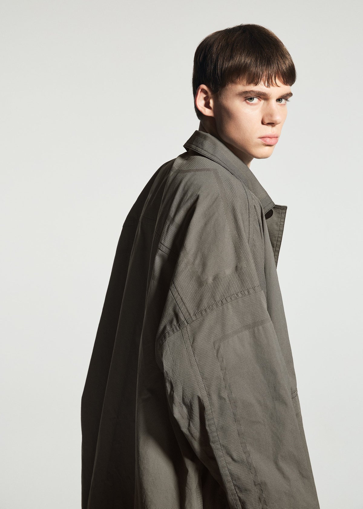 A model wears the A-POC ABLE ISSEY MIYAKE TYPE-U 001-1 type-u-001-1-coat-black.