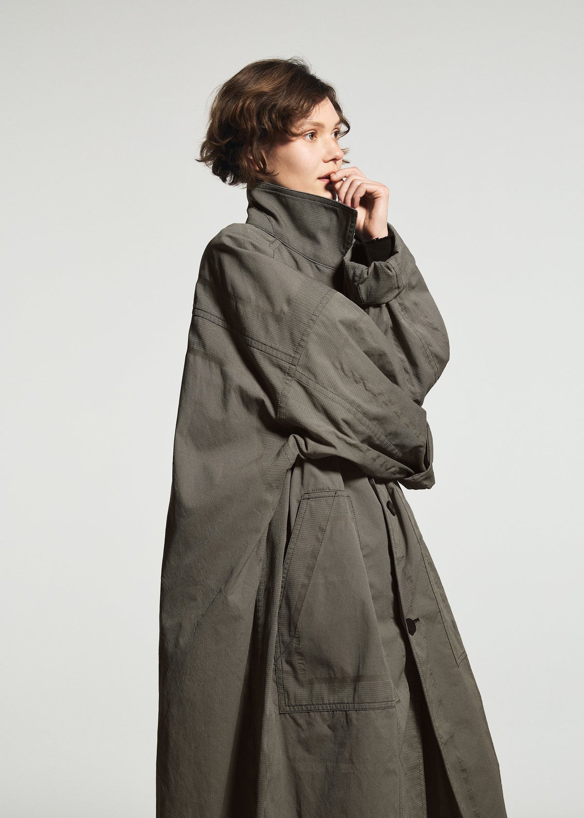 A model wears the A-POC ABLE ISSEY MIYAKE TYPE-U 001-1 type-u-001-1-coat-black.