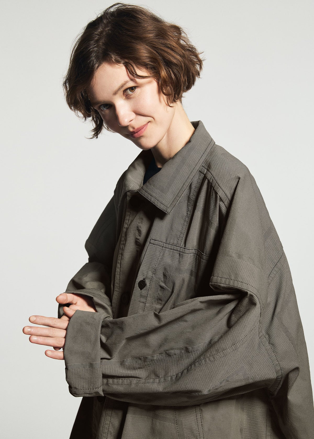 A model wears the A-POC ABLE ISSEY MIYAKE TYPE-U 001-1 type-u-001-1-coat-black.