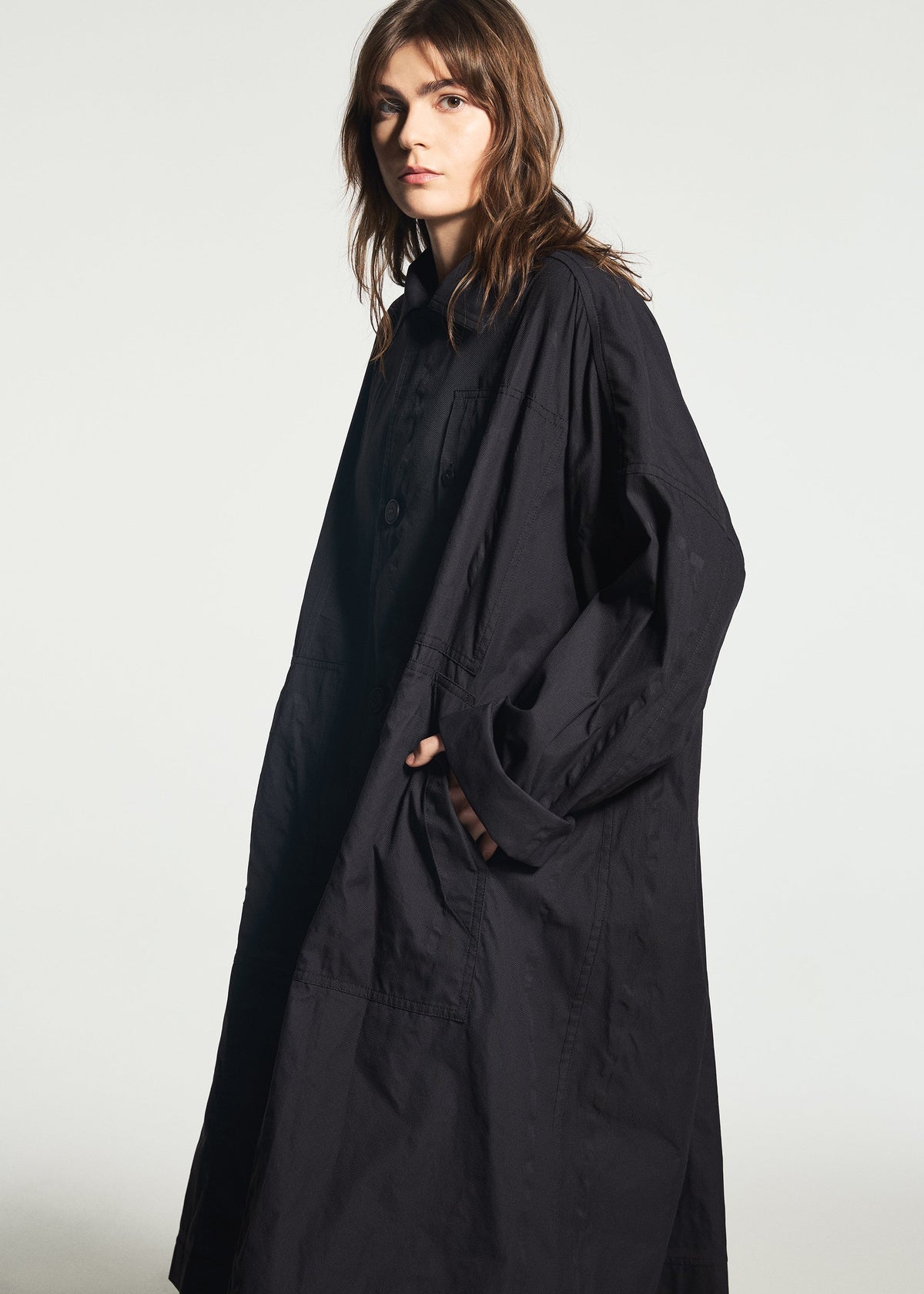 A model wears the A-POC ABLE ISSEY MIYAKE TYPE-U 001-1 type-u-001-1-coat-dark-grey.