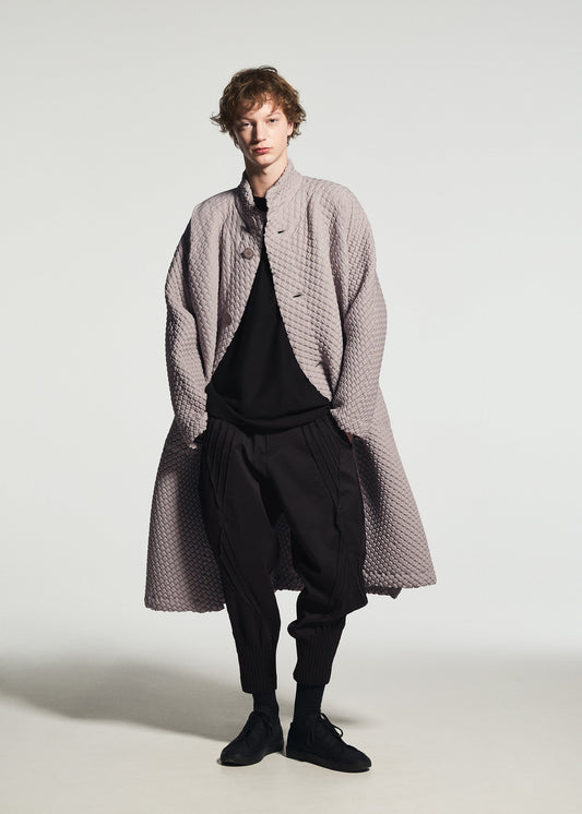 A model wears the A-POC ABLE ISSEY MIYAKE TYPE-O 024 type-o-024-coat-black.