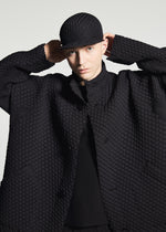 A model wears the A-POC ABLE ISSEY MIYAKE TYPE-O 024 type-o-024-coat-red.