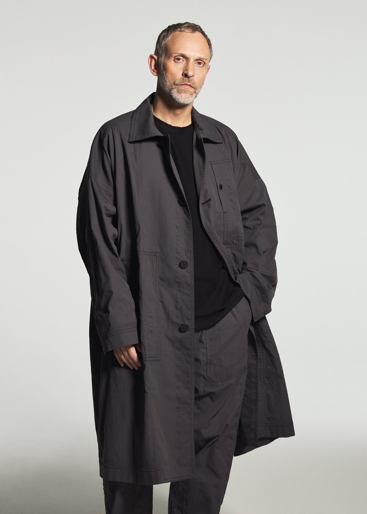 A model wears the A-POC ABLE ISSEY MIYAKE TYPE-U 001-1 type-u-001-1-trousers-dark-grey.