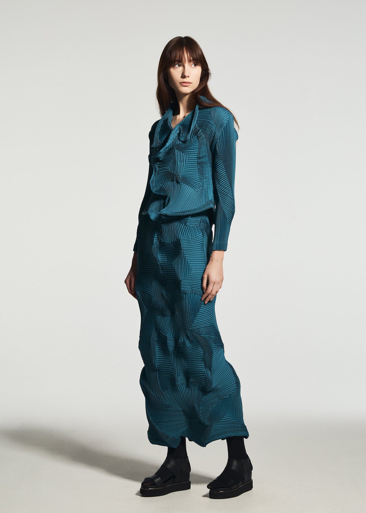 A model wears the A-POC ABLE ISSEY MIYAKE TYPE-O 003-1 type-o-003-1-skirt-turquoise-green-1.