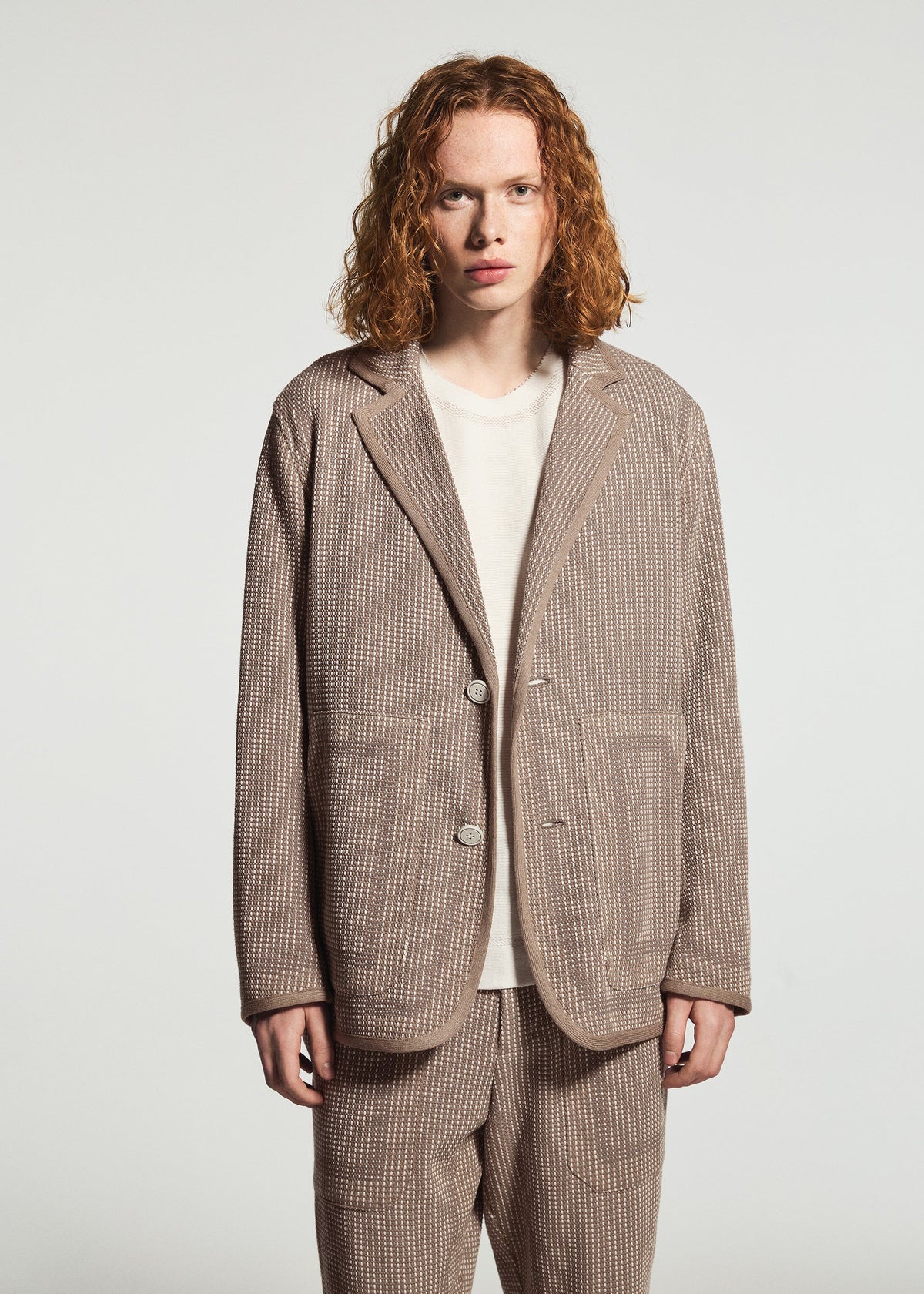 A model wears the A-POC ABLE ISSEY MIYAKE TYPE-K 012 type-k-012-jacket-beige-hued.