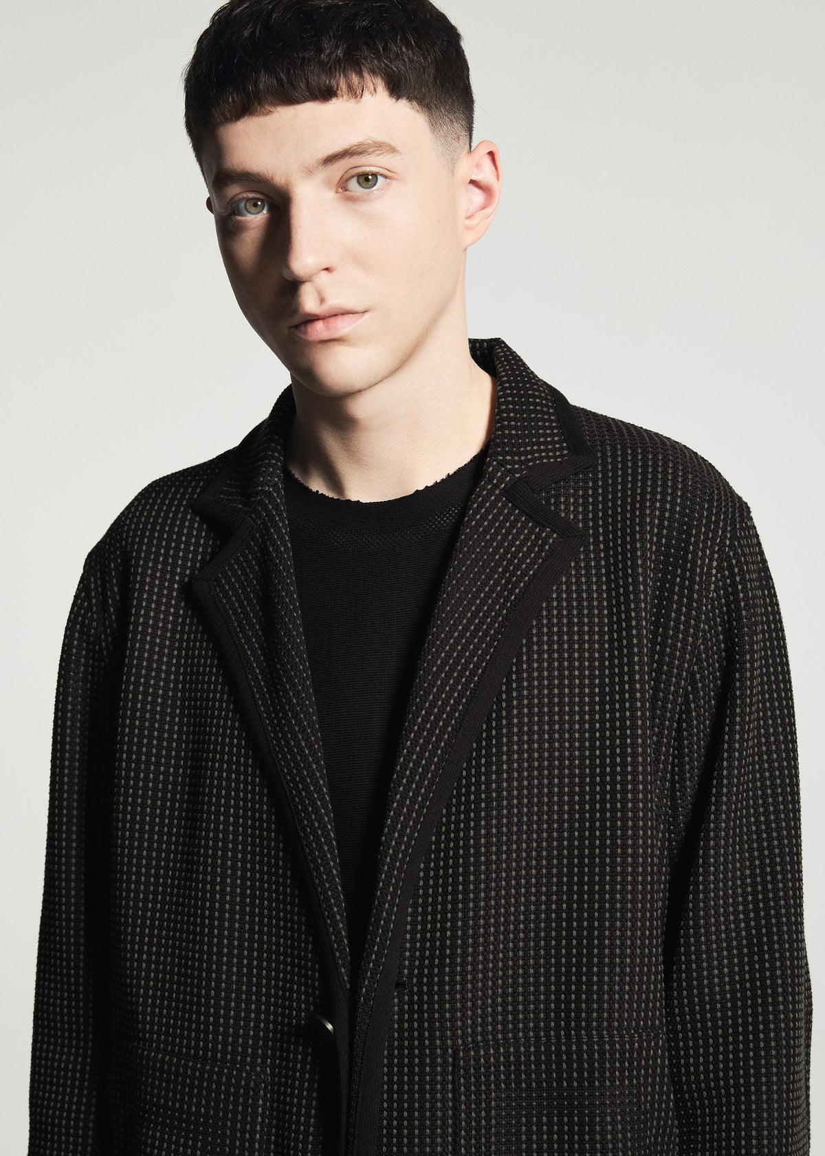A model wears the A-POC ABLE ISSEY MIYAKE TYPE-K 012 type-k-012-jacket-black-hued.