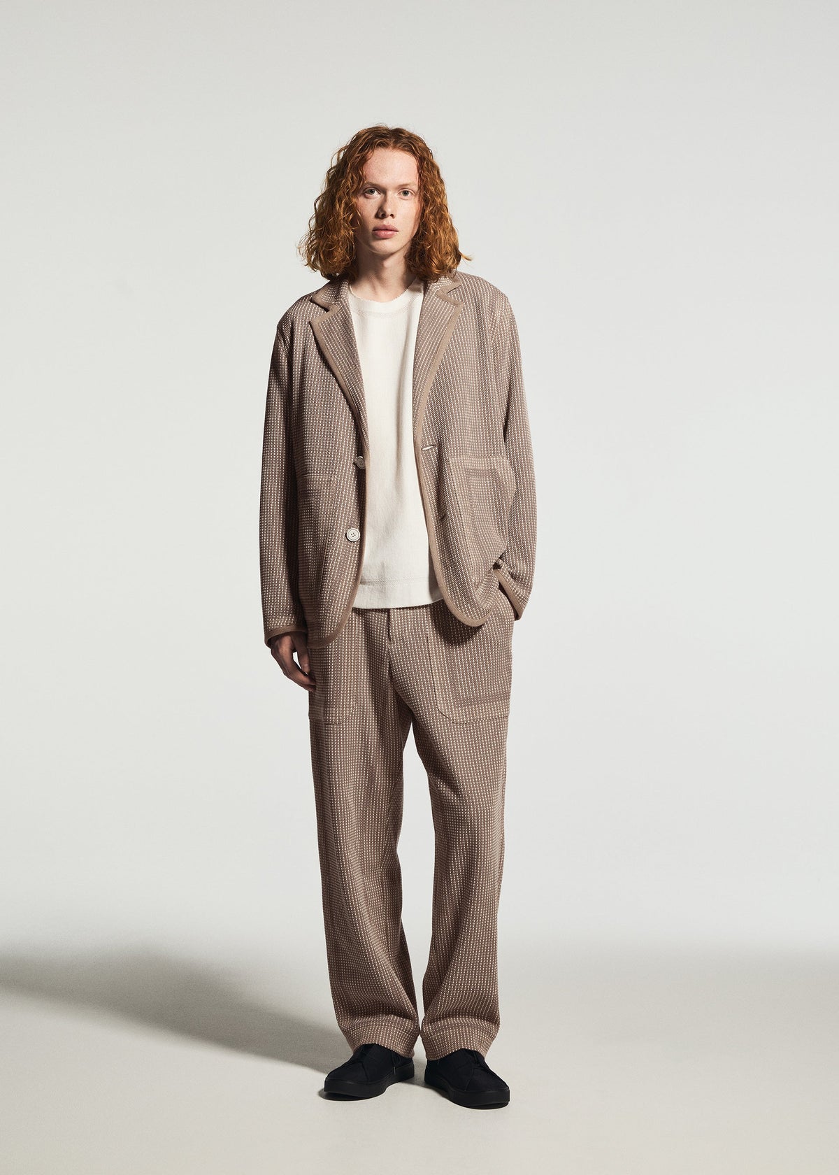 A model wears the A-POC ABLE ISSEY MIYAKE TYPE-K 012 type-k-012-trousers-beige-hued.