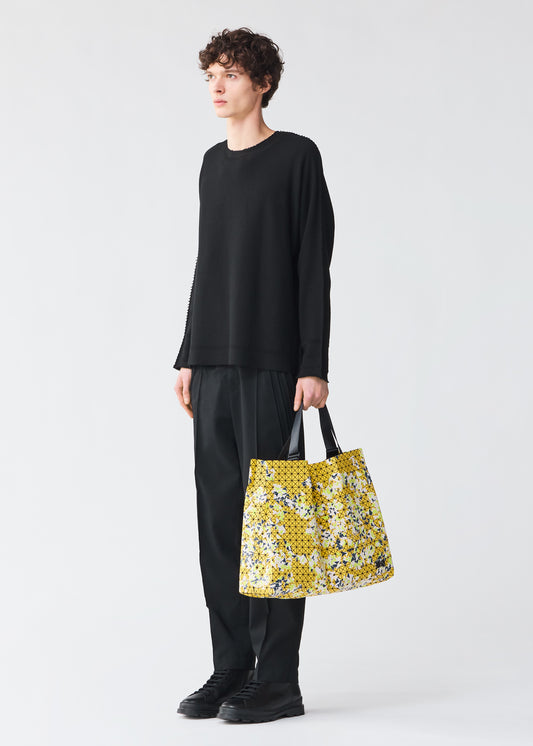 A model wears the BAO BAO ISSEY MIYAKE  CART SPRITZ tote