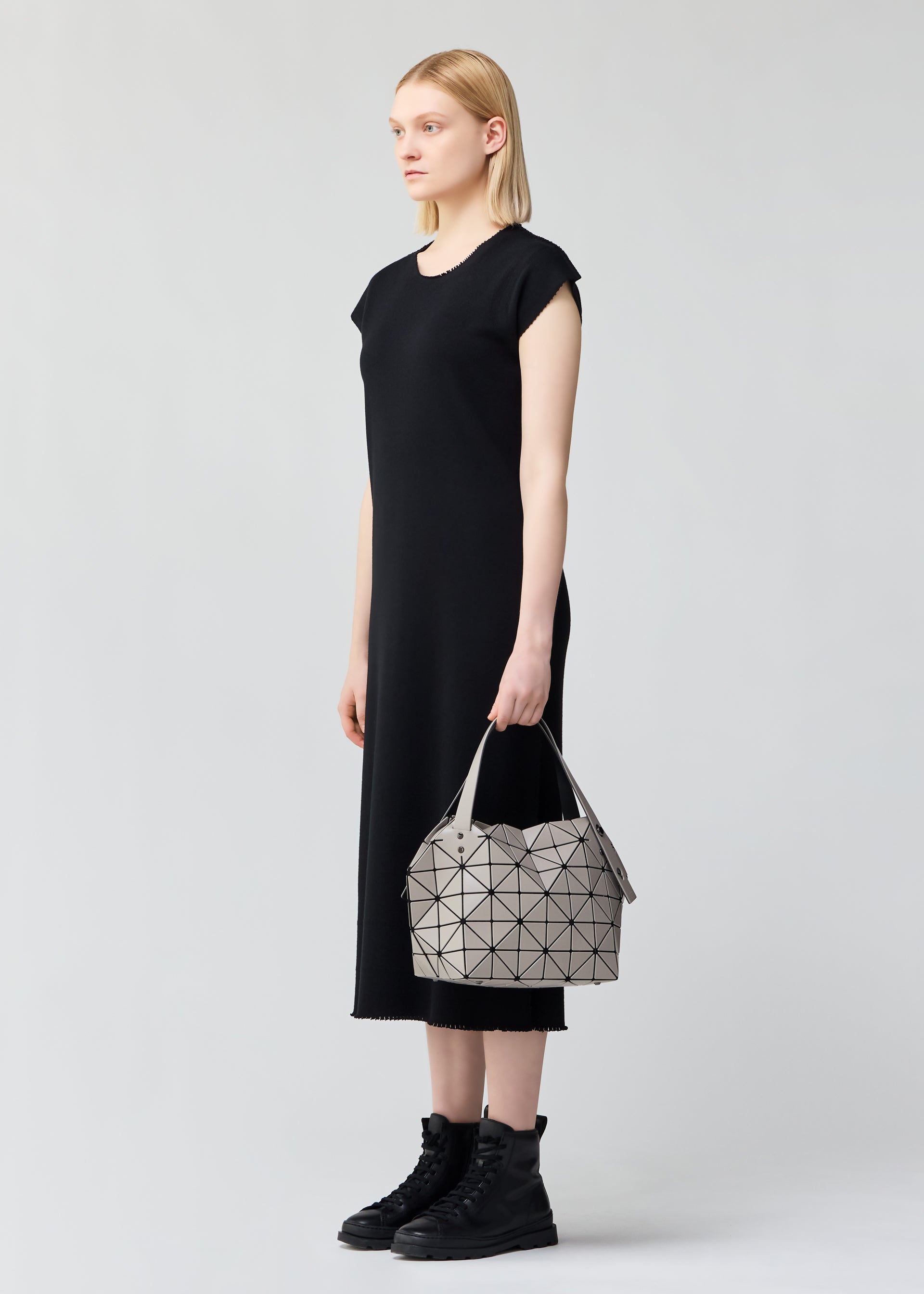 A model wears the BAO BAO ISSEY MIYAKE BOSTON shoulder bag.
