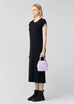 A model wears the BAO BAO ISSEY MIYAKE CARAT hand bag.