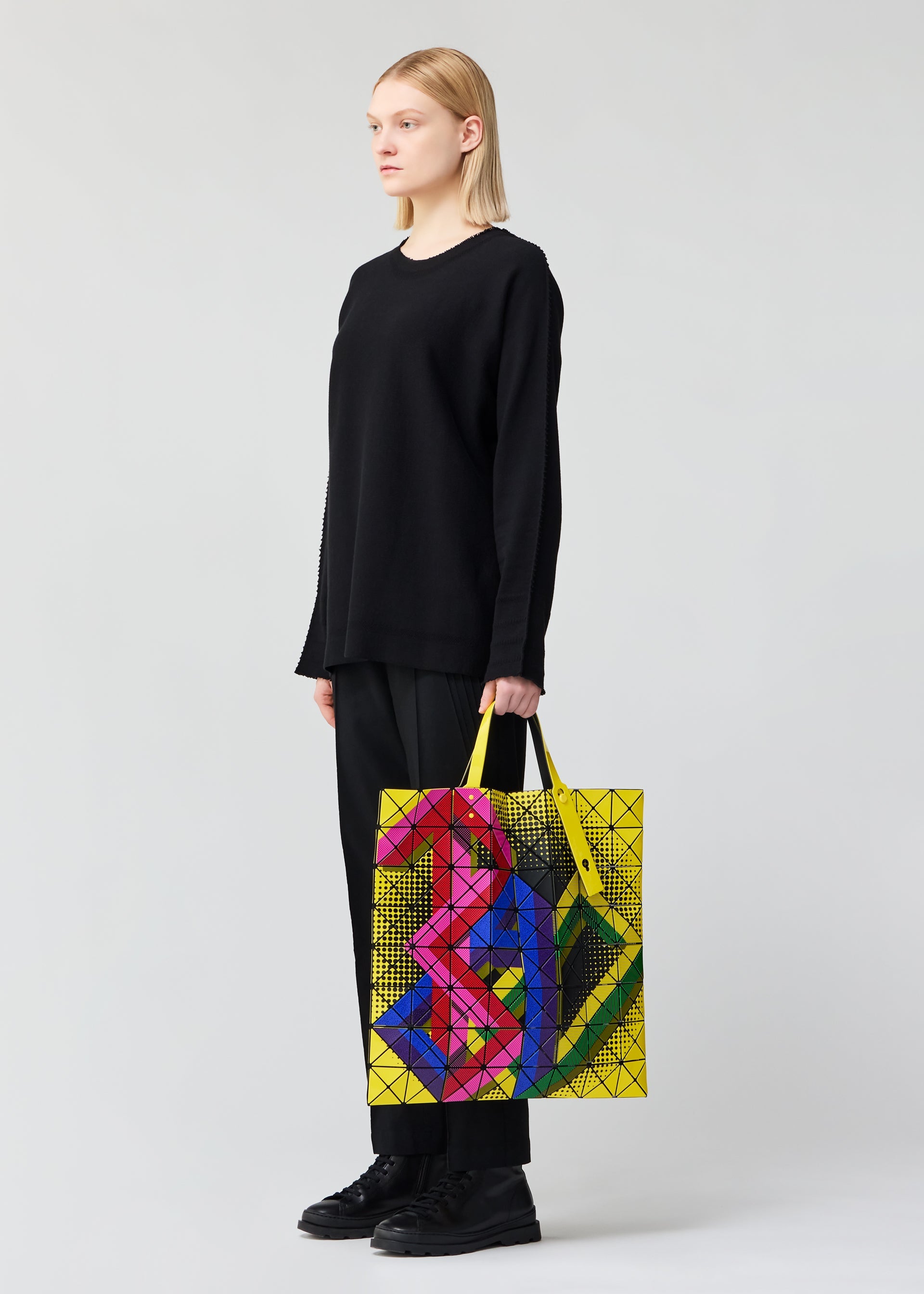 A model wears the BAO BAO ISSEY MIYAKE MANGA tote.
