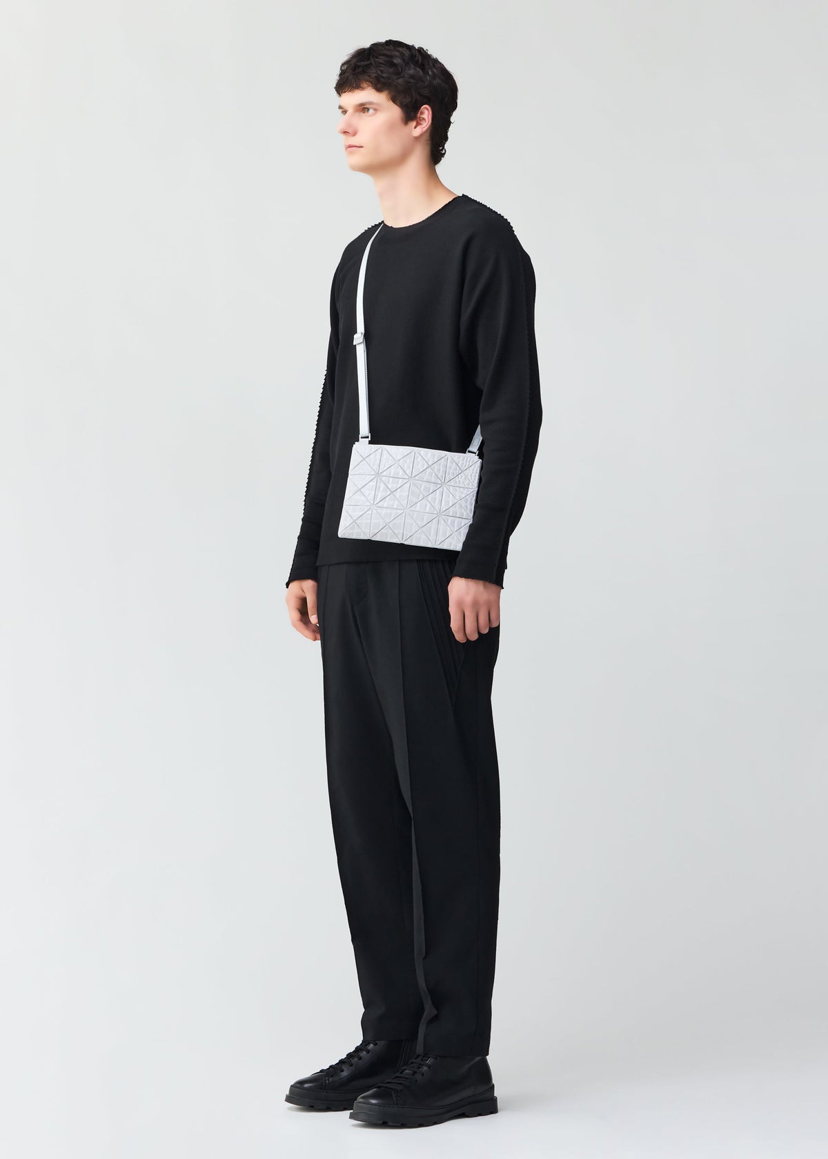 A model wears the BAO BAO ISSEY MIYAKE KAIJU bag.