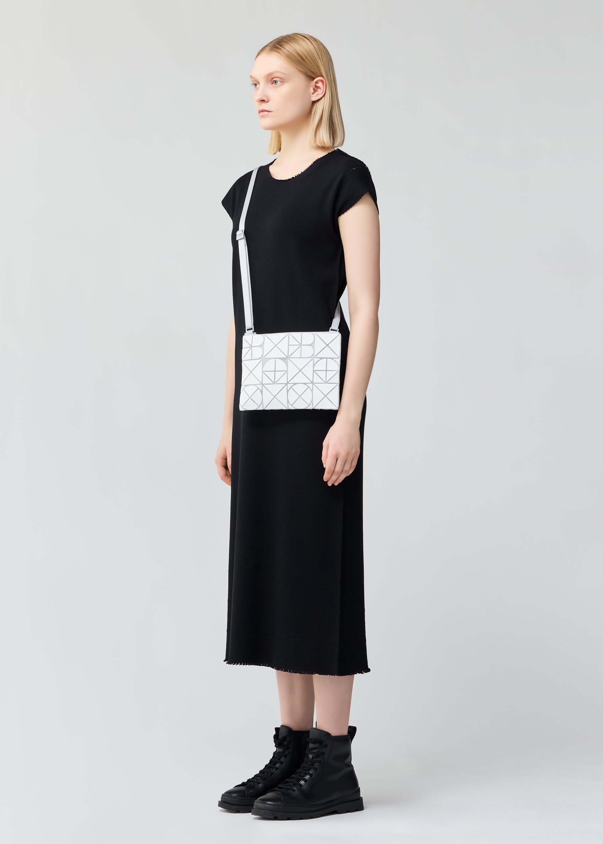 A model wears the BAO BAO ISSEY MIYAKE FONT bag.