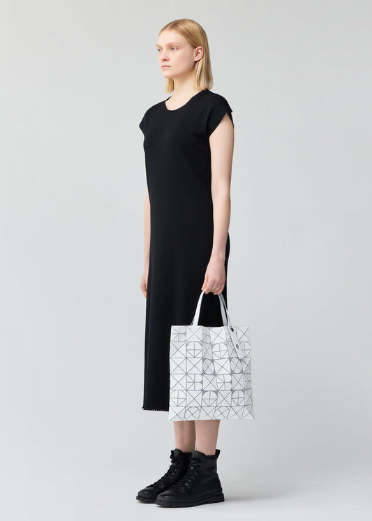 A model wears the BAO BAO ISSEY MIYAKE FONT tote.