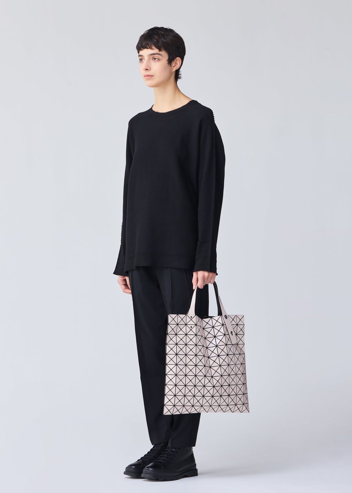 A model wears the BAO BAO ISSEY MIYAKE PRISM tote.