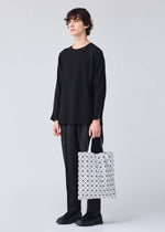 A model wears the BAO BAO ISSEY MIYAKE PRISM tote.