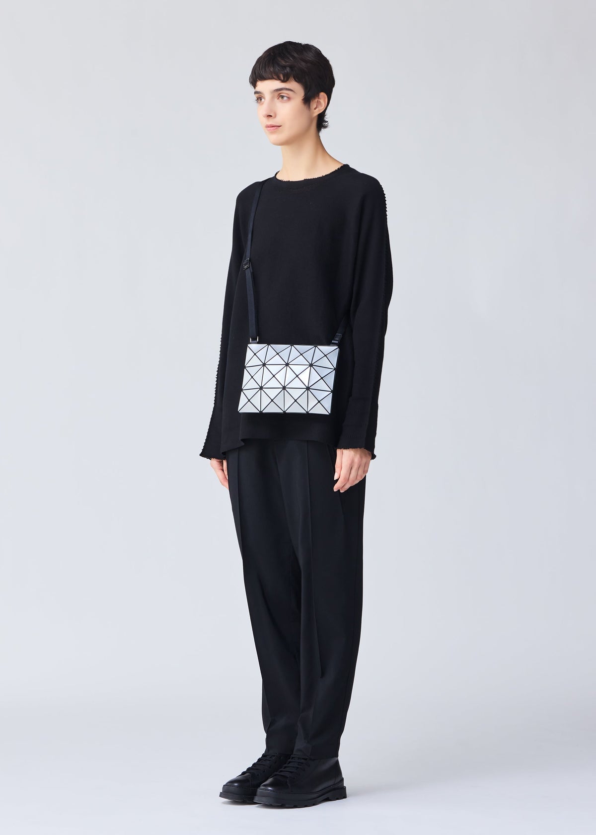 A model wears the BAO BAO ISSEY MIYAKE LUCENT crossbody.