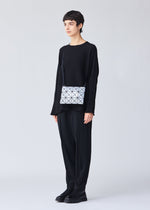 A model wears the BAO BAO ISSEY MIYAKE LUCENT crossbody.