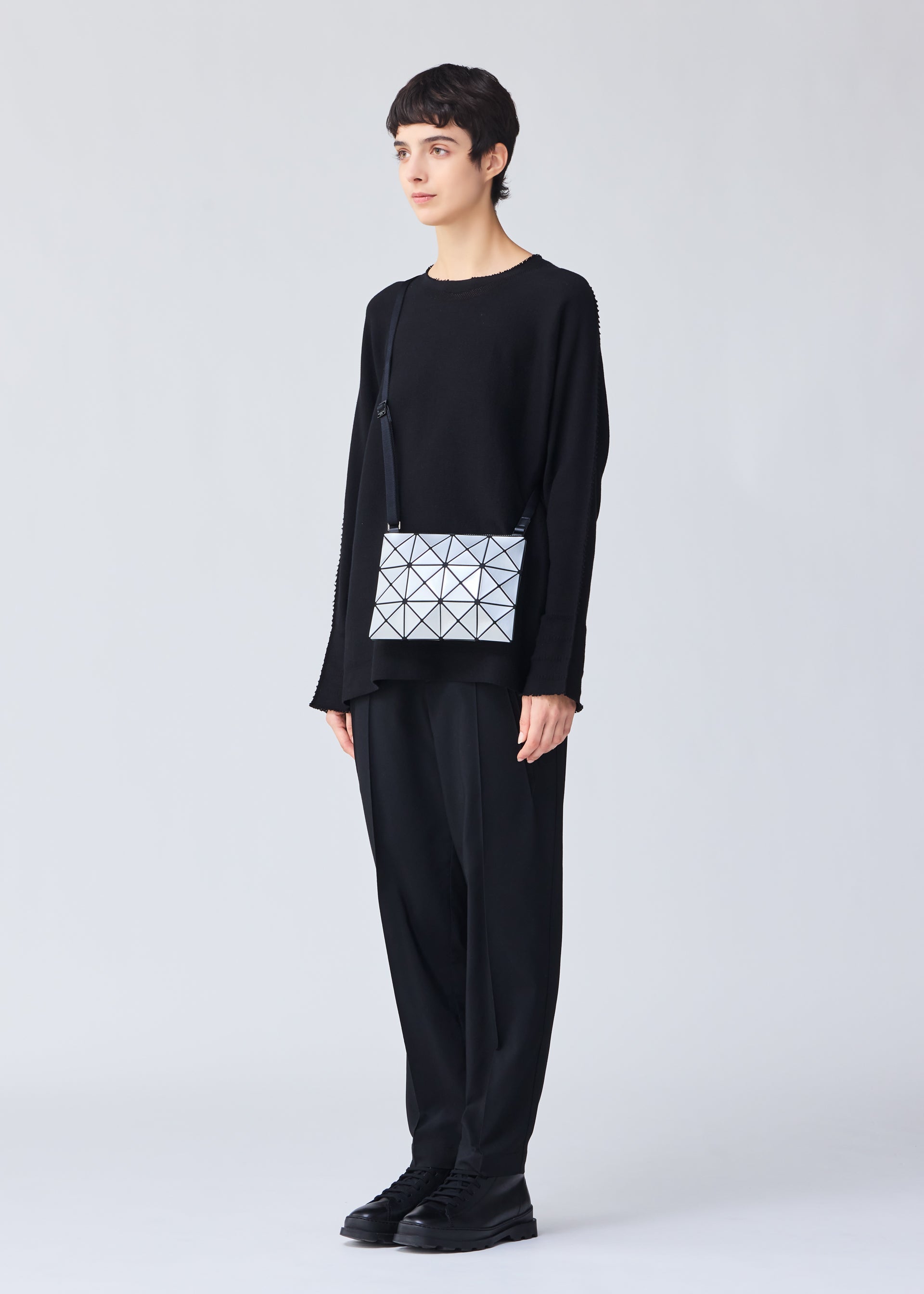 A model wears the BAO BAO ISSEY MIYAKE LUCENT crossbody.