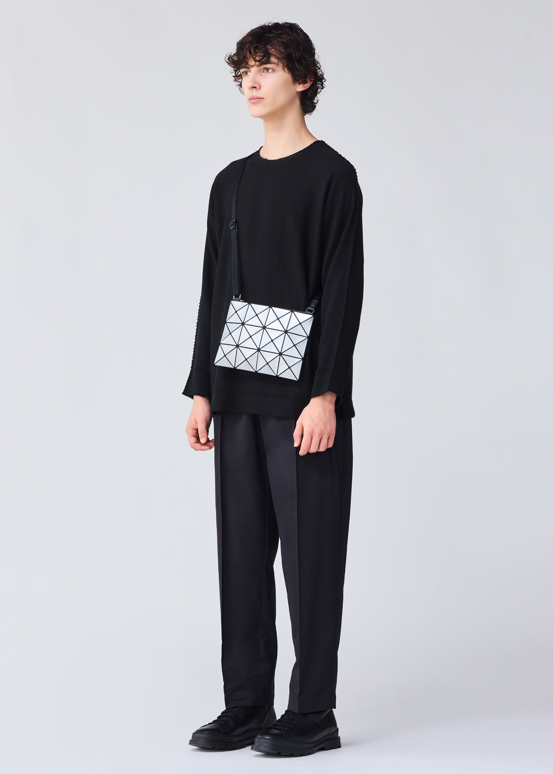 A model wears the BAO BAO ISSEY MIYAKE LUCENT crossbody.
