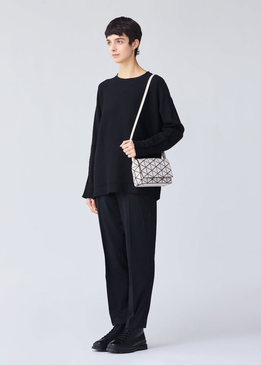 A model wears the BAO BAO ISSEY MIYAKE FOSSETTE shoulder bag.