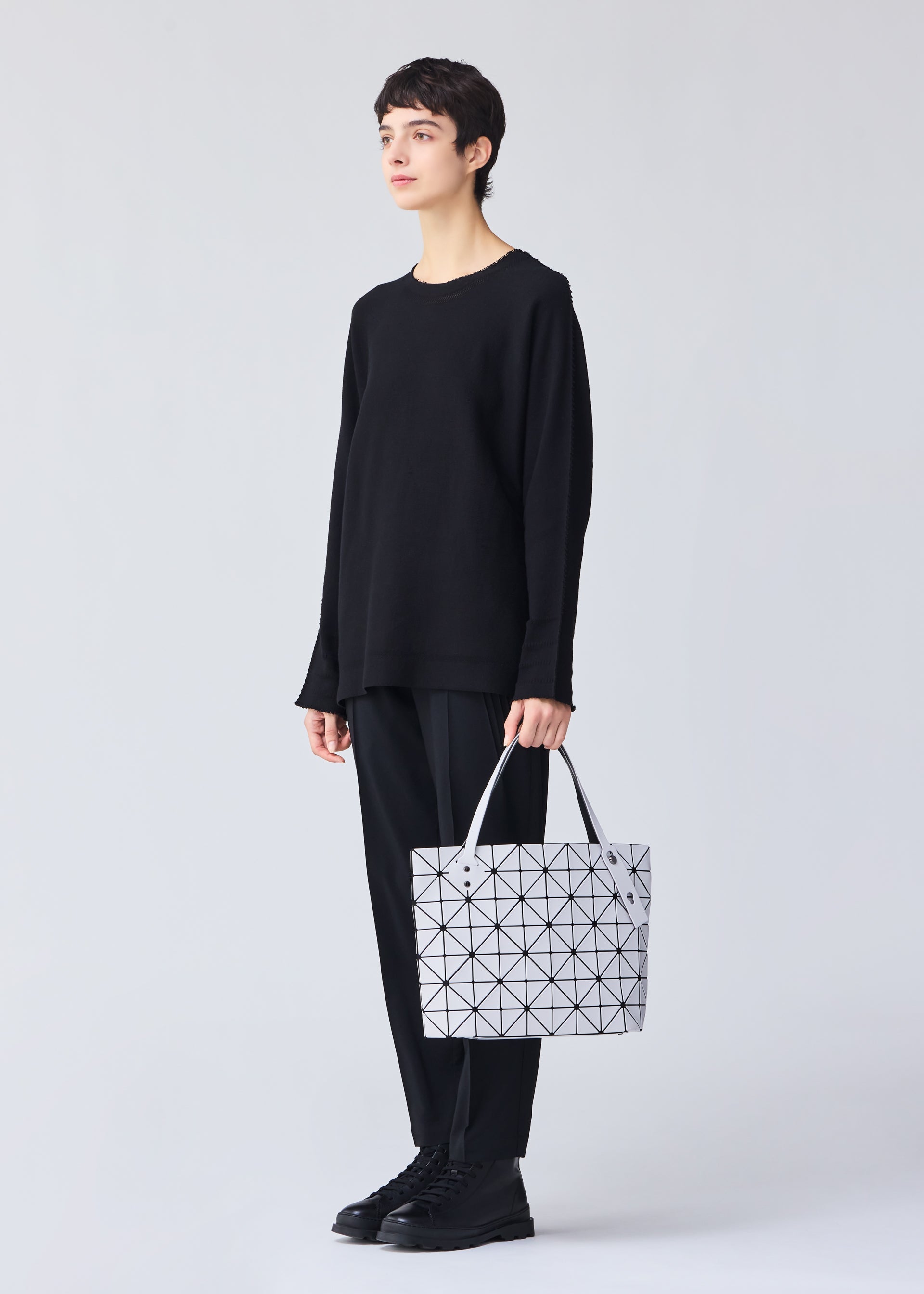 A model wears the BAO BAO ISSEY MIYAKE ROCK MATTE 0.