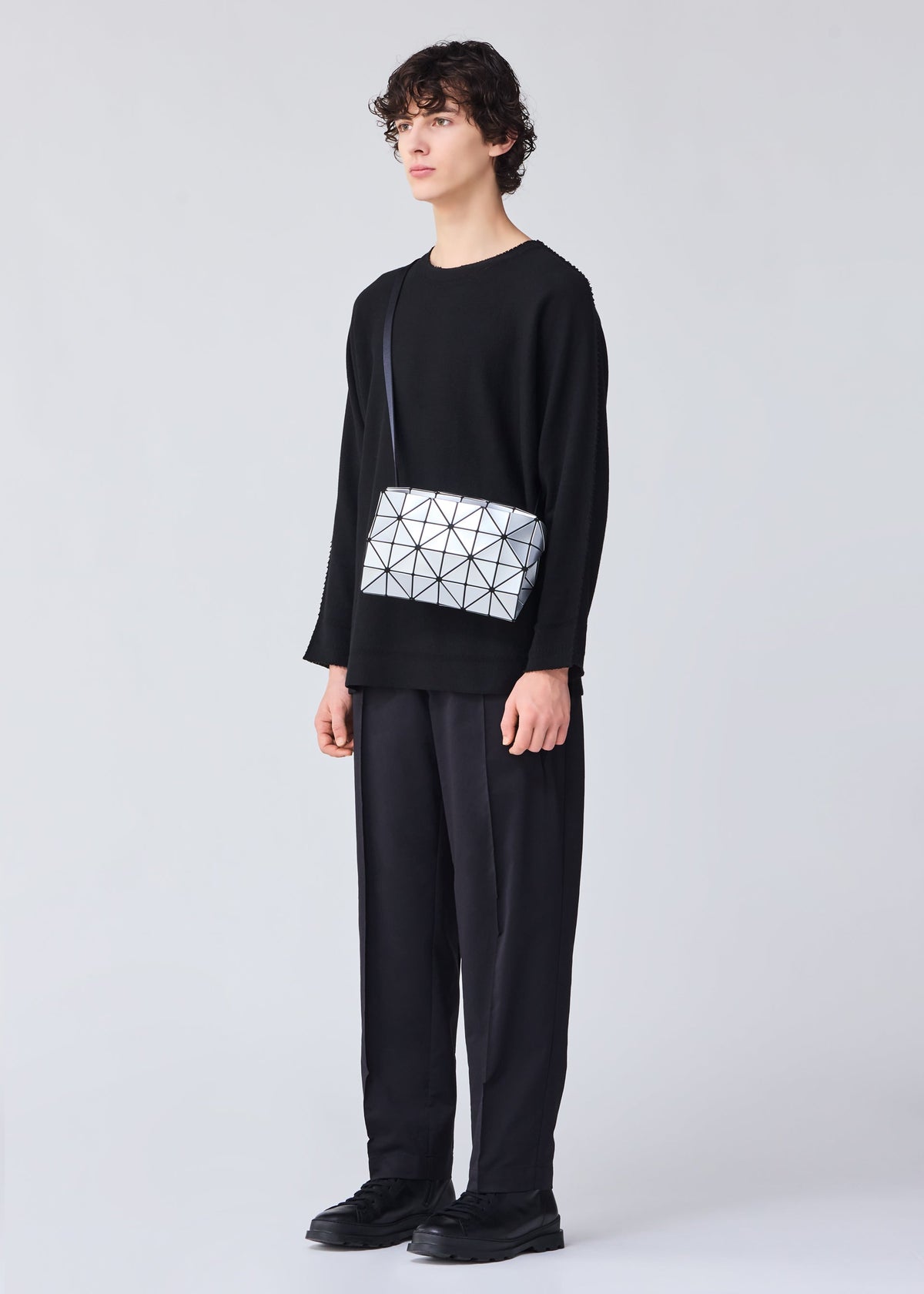 A model wears the BAO BAO ISSEY MIYAKE CARTON shoulder bag.
