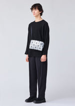 A model wears the BAO BAO ISSEY MIYAKE CARTON shoulder bag.