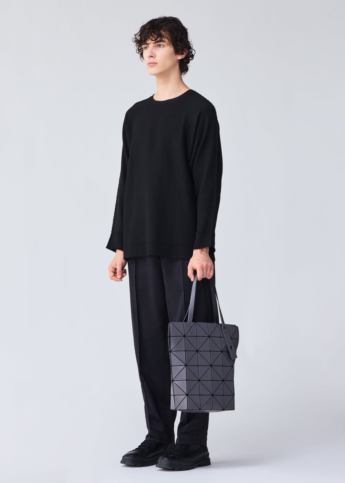 A model wears the BAO BAO ISSEY MIYAKE BLOCKY tote.