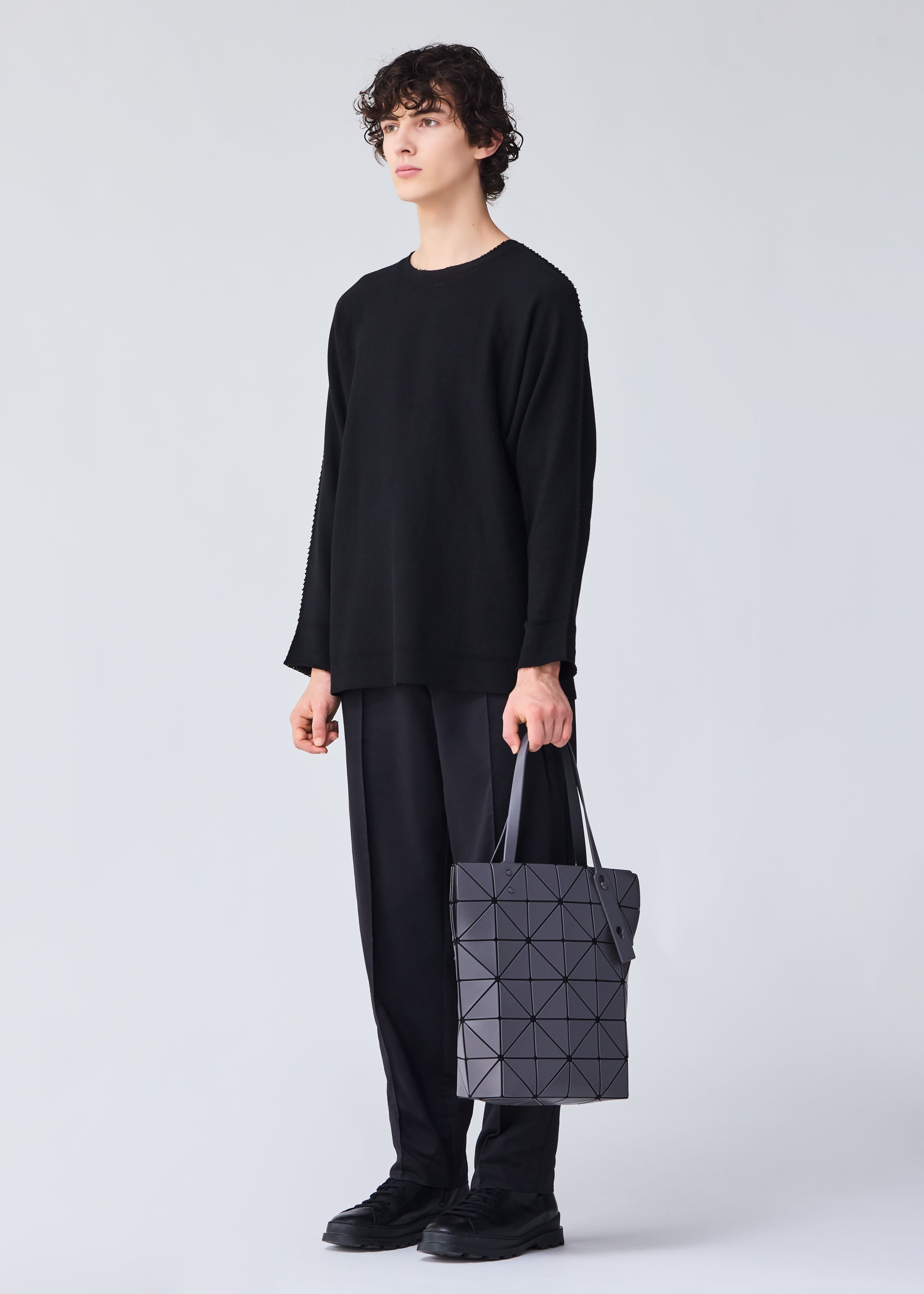 A model wears the BAO BAO ISSEY MIYAKE BLOCKY tote.