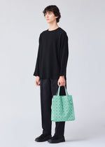 A model wears the BAO BAO ISSEY MIYAKE PRISM PLUS tote.