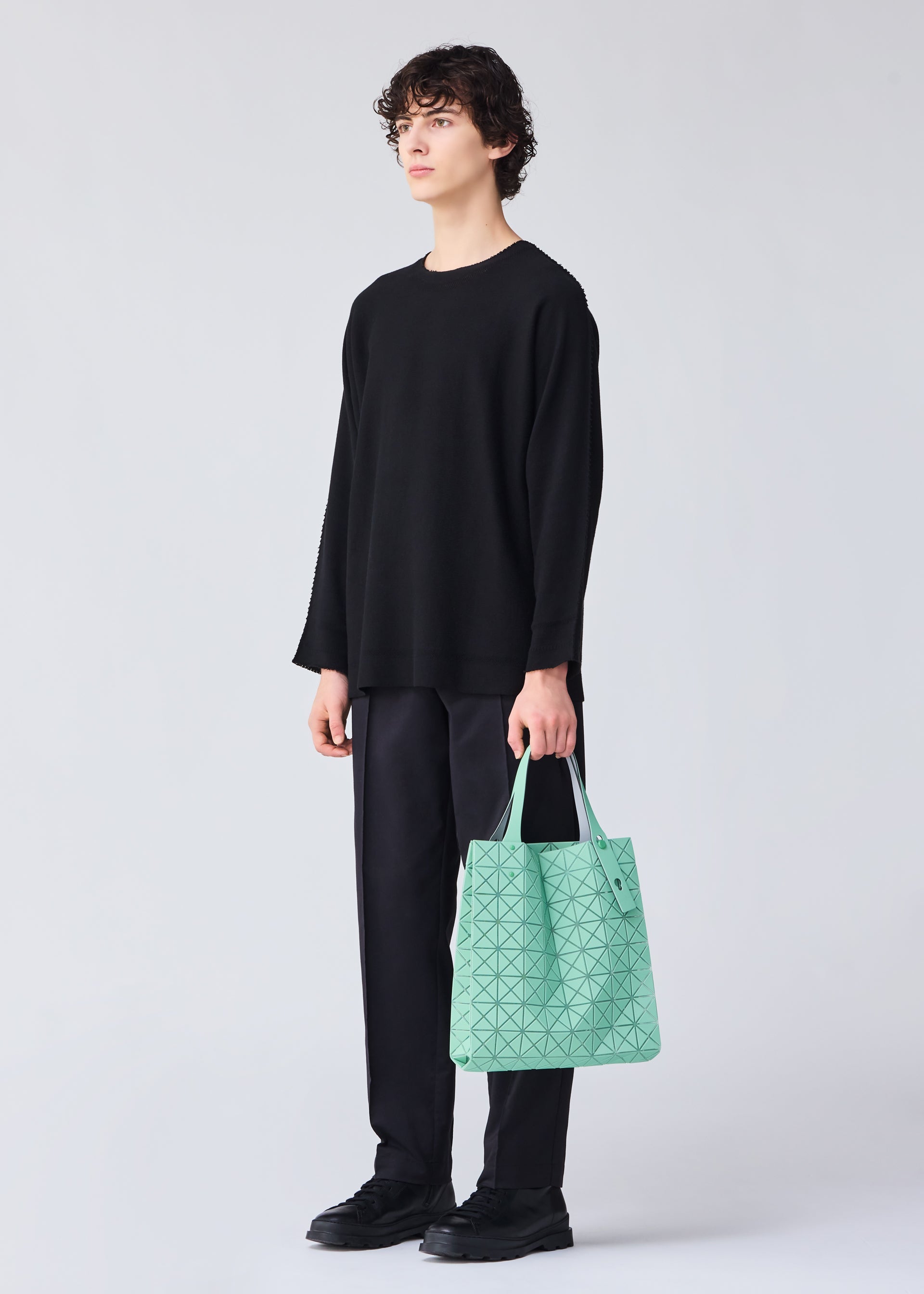 A model wears the BAO BAO ISSEY MIYAKE PRISM PLUS tote.