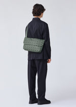 A model wears the BAO BAO ISSEY MIYAKE PRISM SAC shoulder bag.