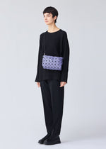 A model wears the BAO BAO ISSEY MIYAKE LOOP MATTE shoulder bag.