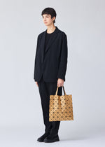 A model wears the BAO BAO ISSEY MIYAKE LUCENT METALLIC tote.