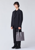A model wears the BAO BAO ISSEY MIYAKE LUCENT METALLIC tote.