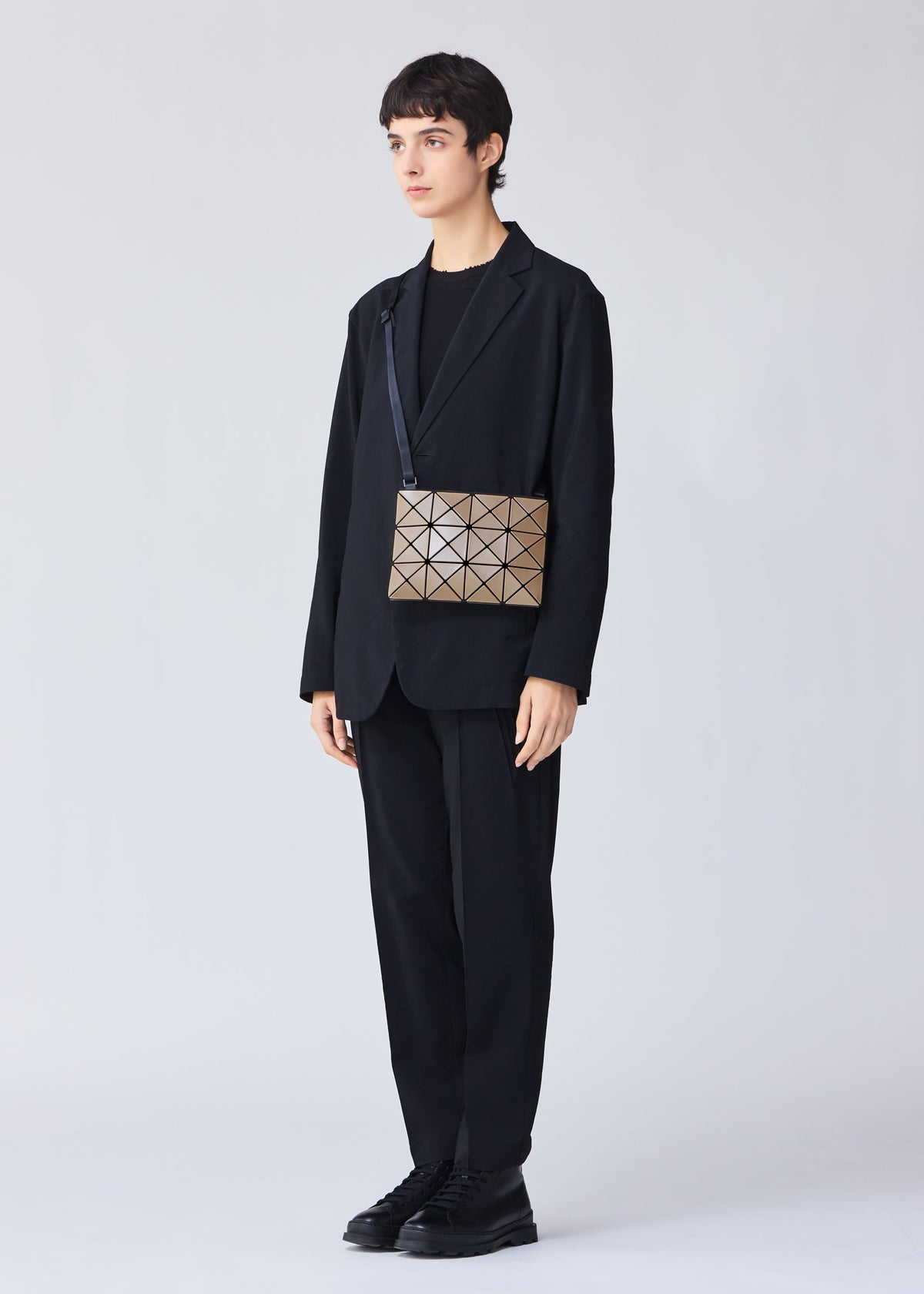 A model wears the BAO BAO ISSEY MIYAKE LUCENT METALLIC crossbody.