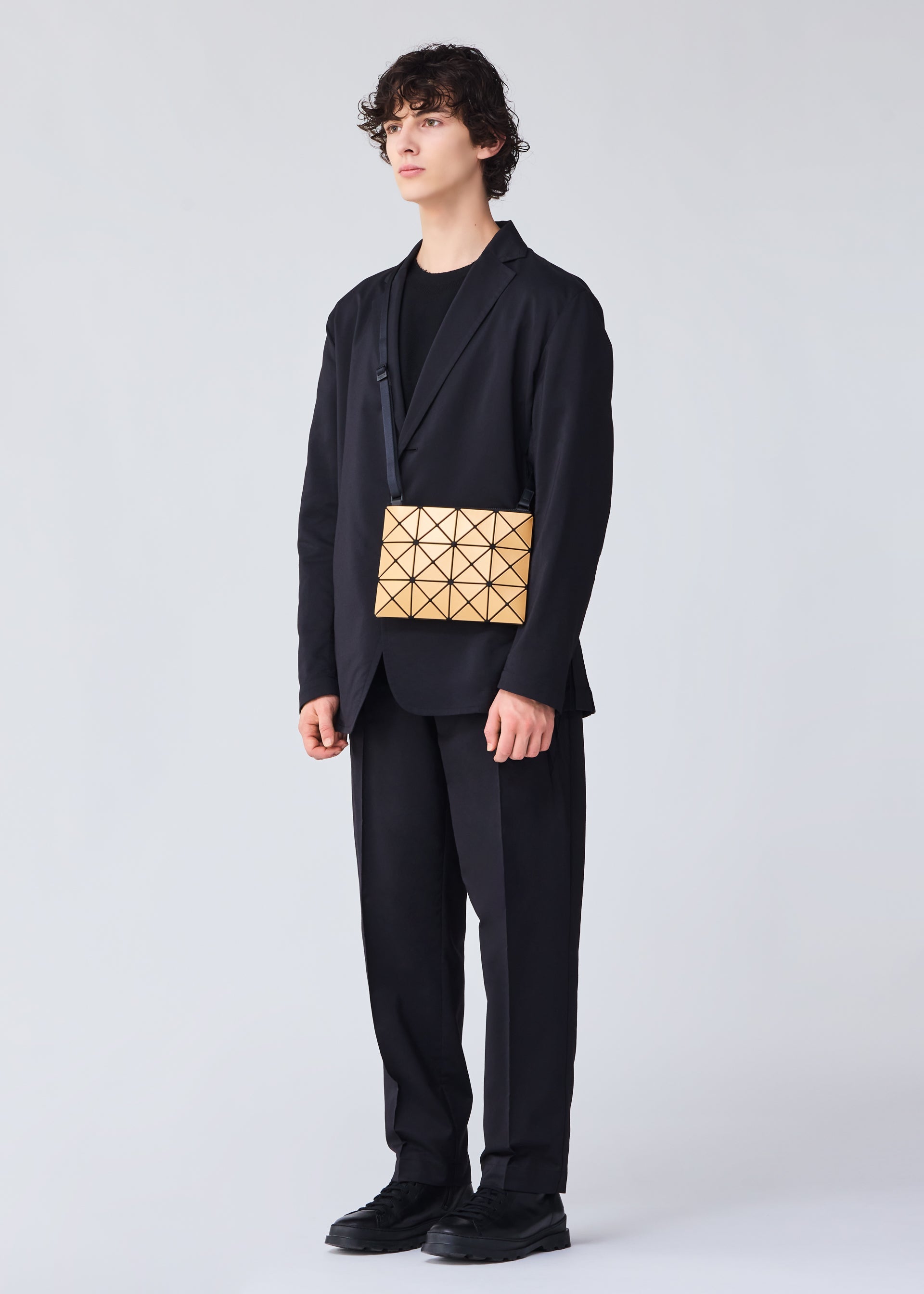 A model wears the BAO BAO ISSEY MIYAKE LUCENT METALLIC crossbody.