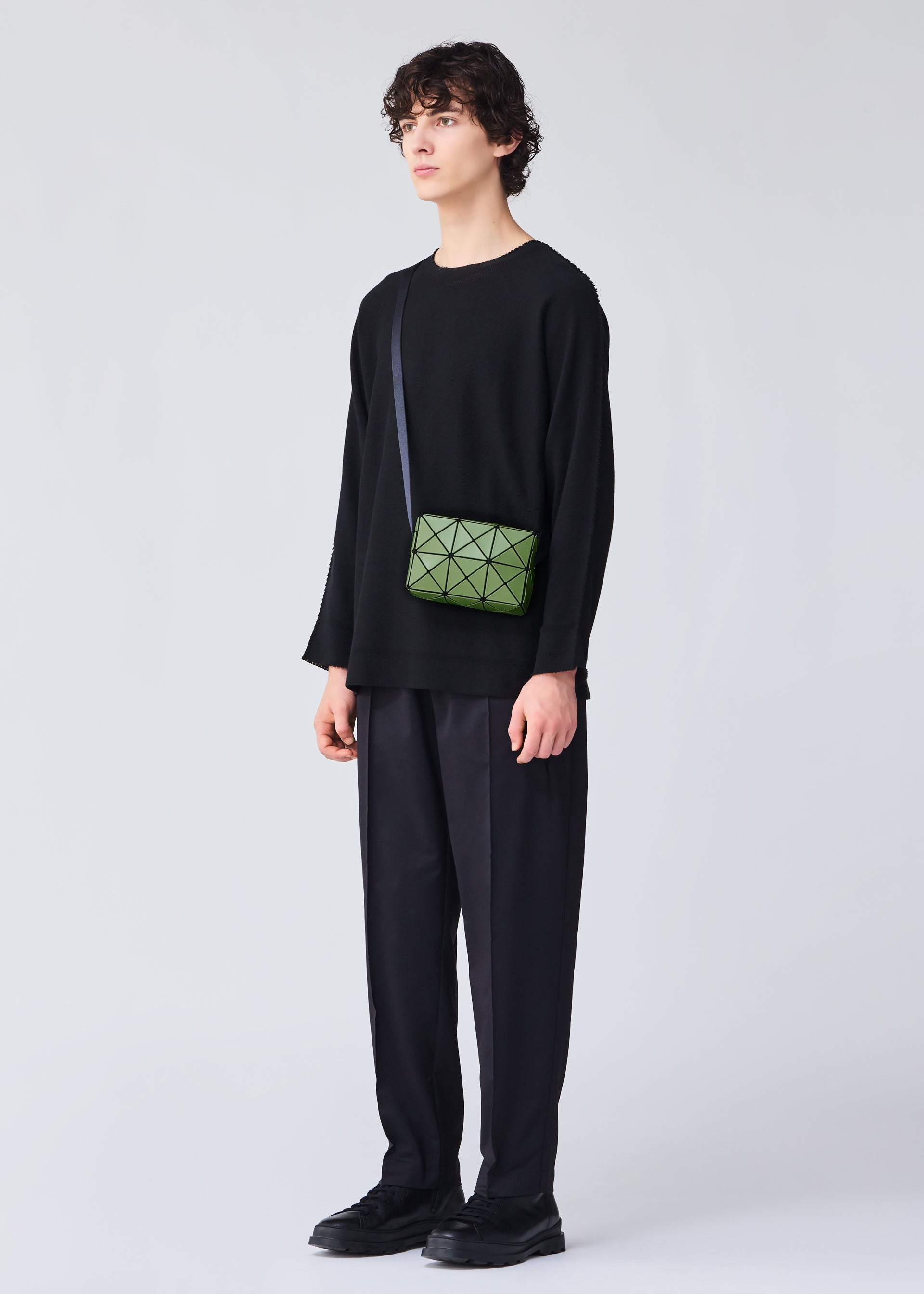 A model wears the BAO BAO ISSEY MIYAKE CUBOID shoulder bag.