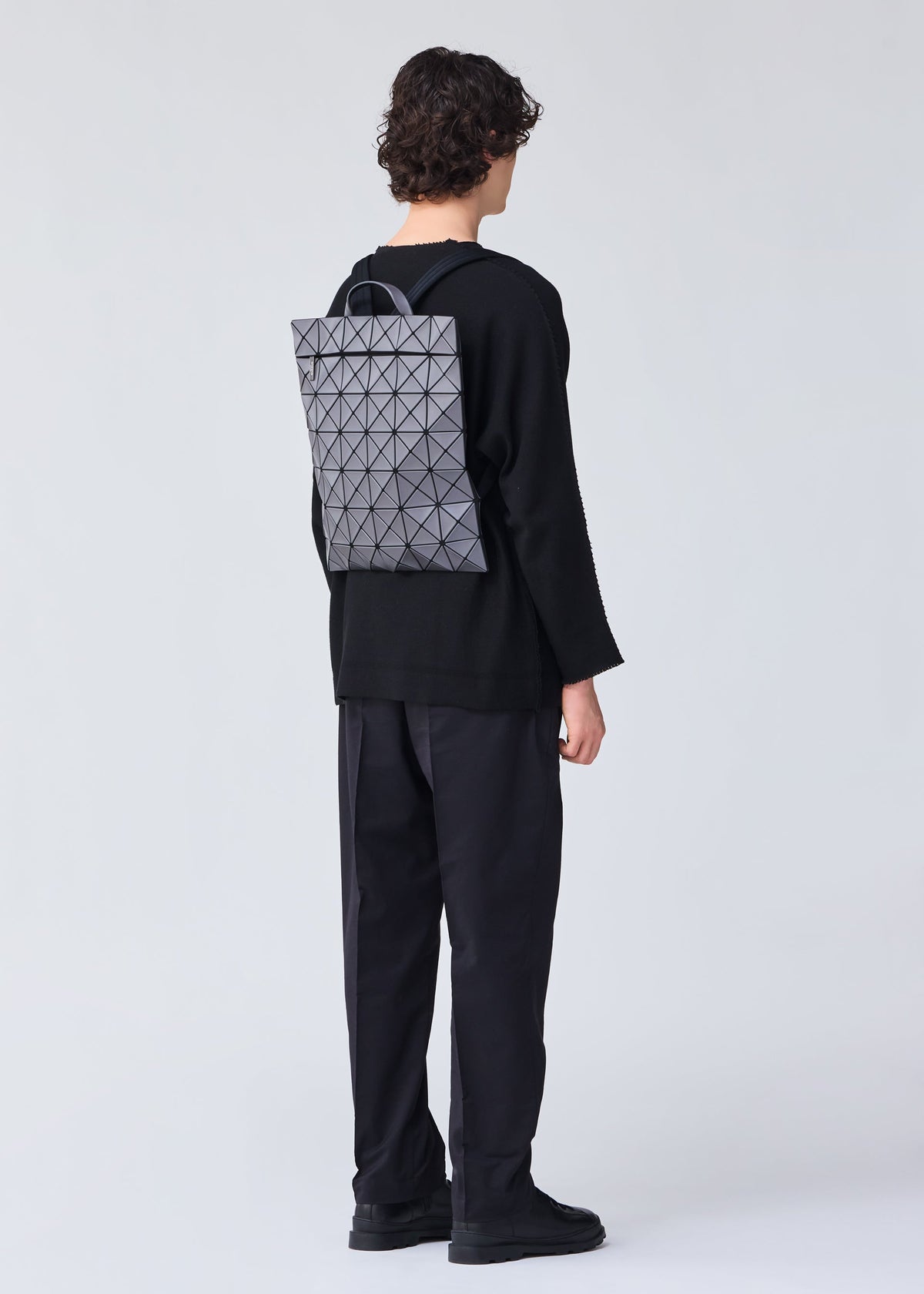 A model wears the BAO BAO ISSEY MIYAKE FLAT PACK backpack.