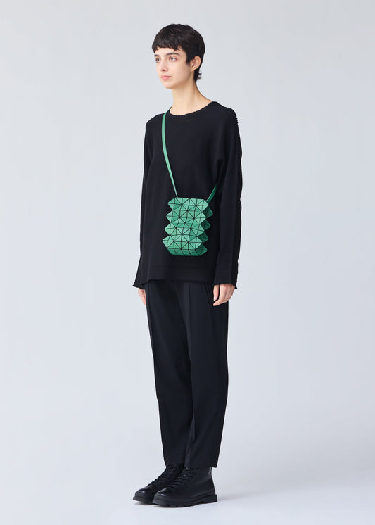 A model wears the BAO BAO ISSEY MIYAKE GROWTH shoulder bag.
