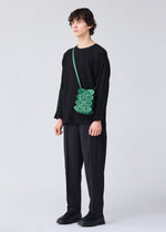 A model wears the BAO BAO ISSEY MIYAKE GROWTH shoulder bag.