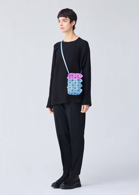 A model wears the BAO BAO ISSEY MIYAKE GROWTH shoulder bag.